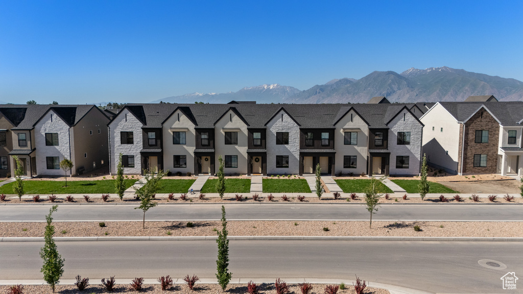 Aerial view of residential area featuring a mountainous background