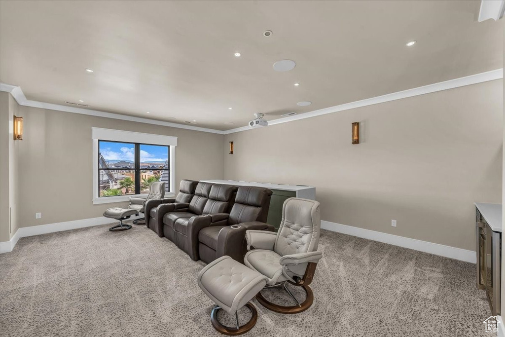 Home theater featuring carpet floors, ornamental molding, and recessed lighting