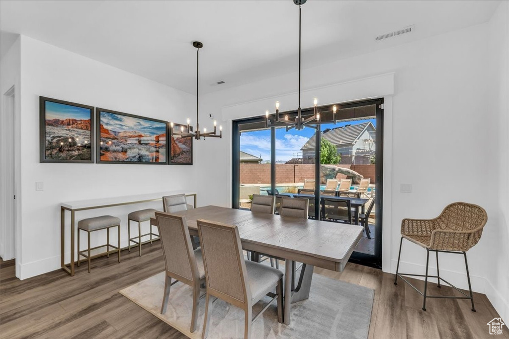 Dining space featuring a chandelier and wood finished floors