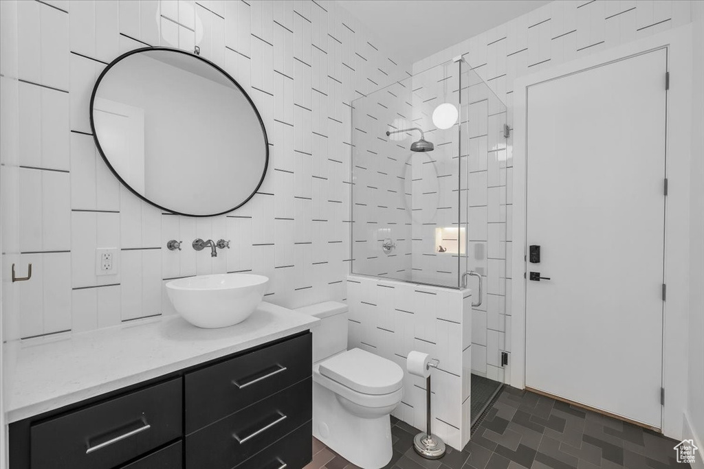 Full bath featuring a shower stall and vanity