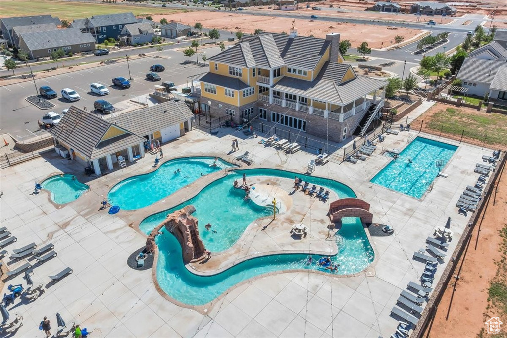 Community pool with a fenced backyard, a patio, and a jacuzzi