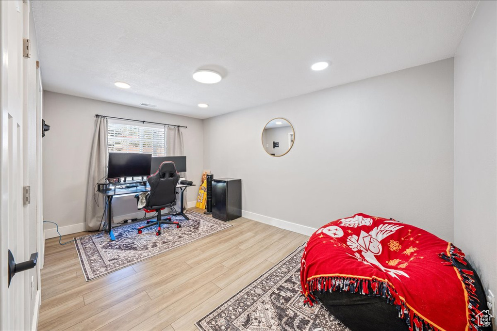 Office featuring wood finished floors and recessed lighting