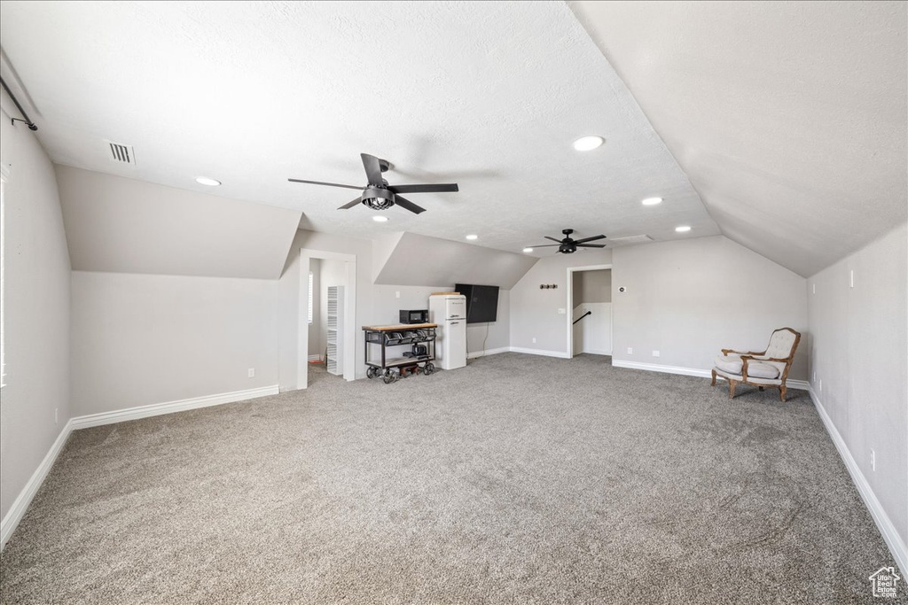 Additional living space with vaulted ceiling, carpet flooring, a ceiling fan, and recessed lighting