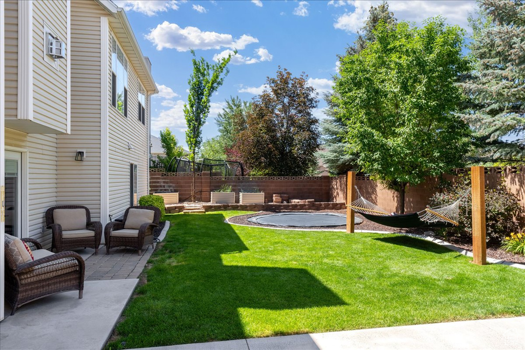 Fenced backyard with a patio