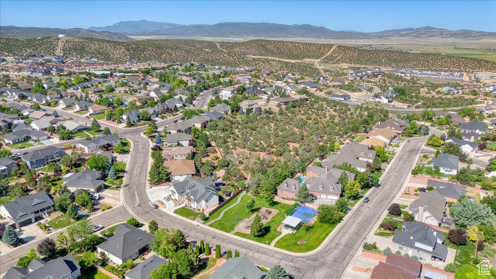 Aerial view of property\'s location with nearby suburban area and mountains