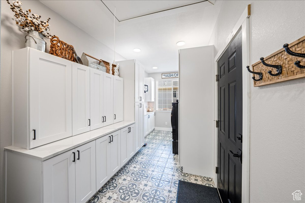 Hallway featuring light tile patterned floors and recessed lighting