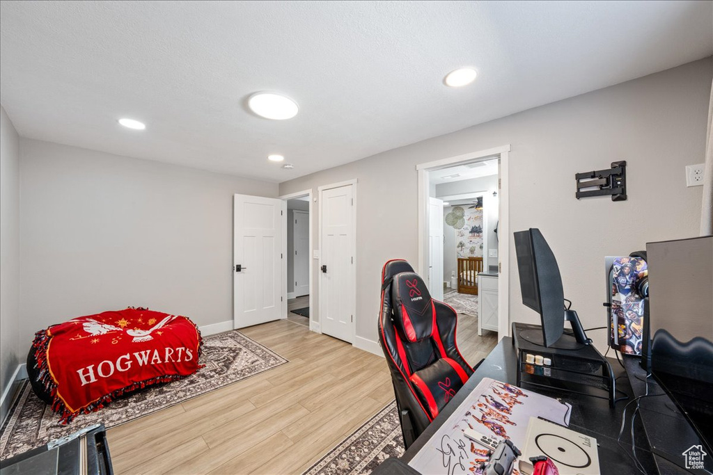Office area with wood finished floors and recessed lighting