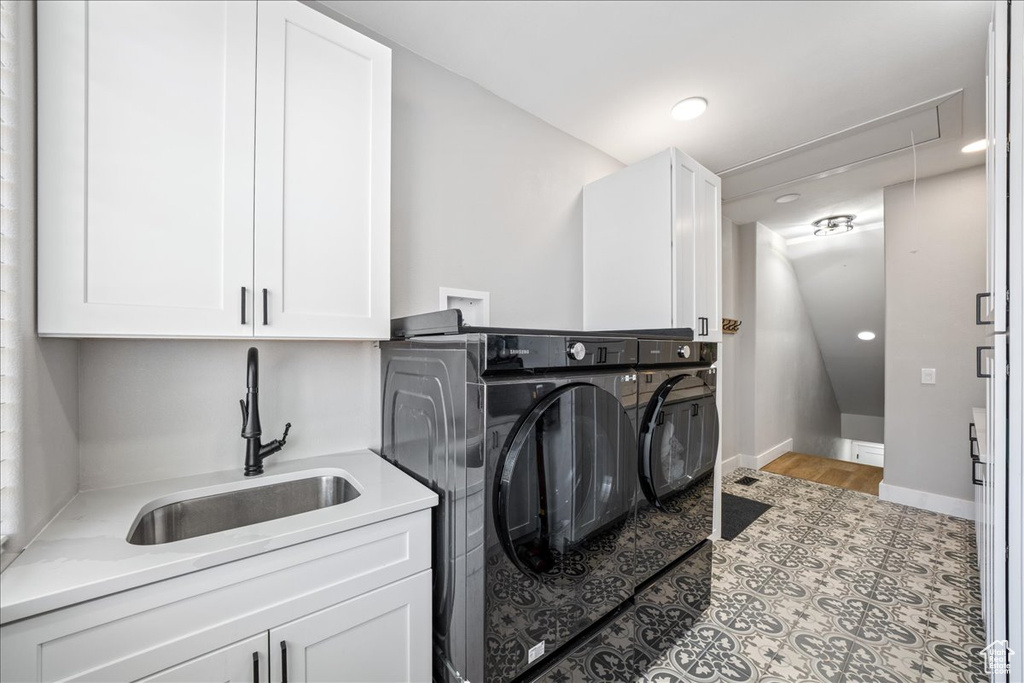 Laundry area featuring separate washer and dryer, cabinet space, attic access, and recessed lighting