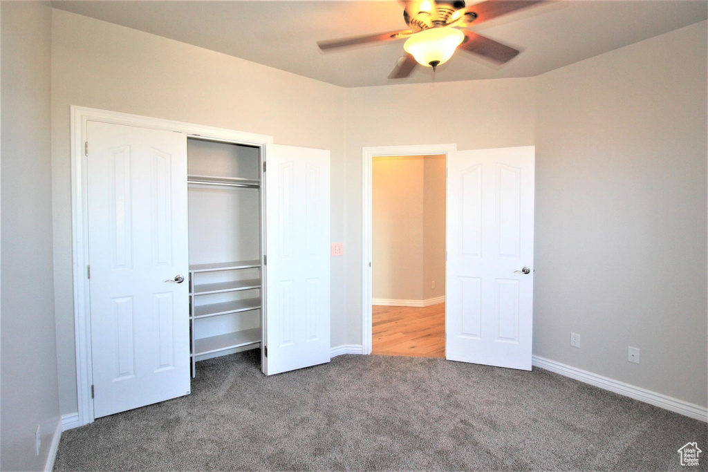 Unfurnished bedroom with carpet floors, a closet, and a ceiling fan