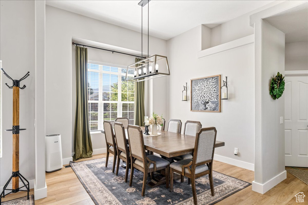 Dining room featuring a chandelier and light wood-type flooring
