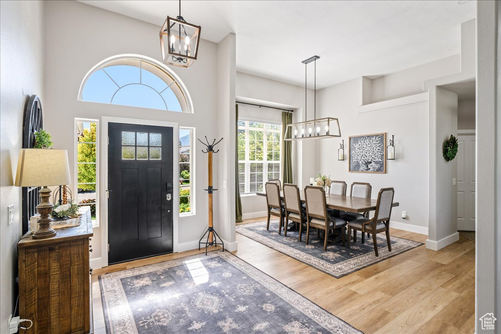 Entrance foyer featuring a chandelier and wood finished floors