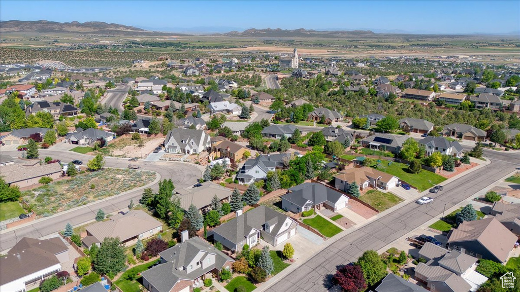 Aerial overview of property\'s location with a mountainous background and nearby suburban area
