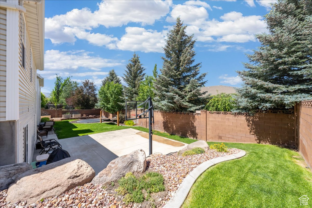 Fenced backyard featuring a patio