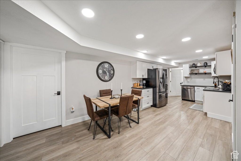 Dining area featuring light wood-style floors and recessed lighting