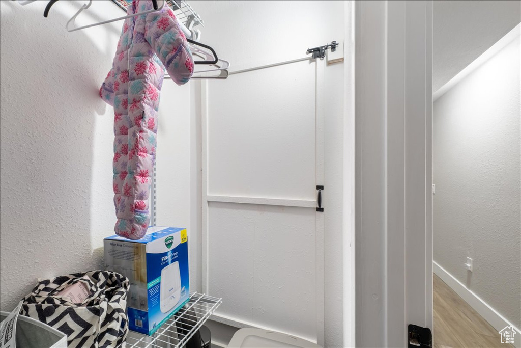 Bathroom with wood finished floors and baseboards