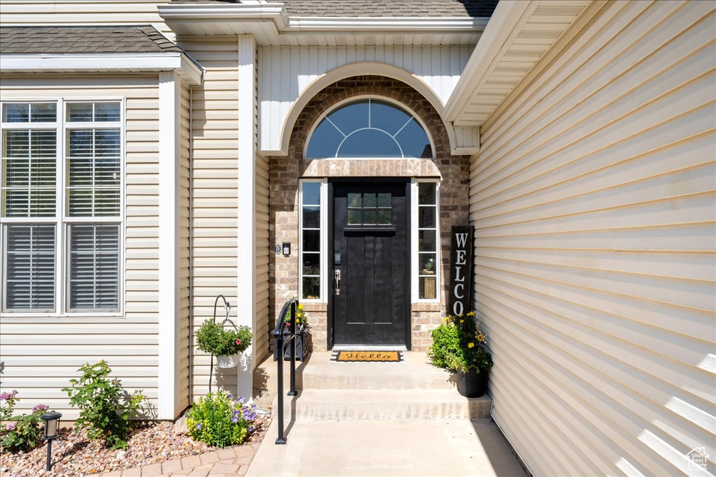 Property entrance featuring roof with shingles