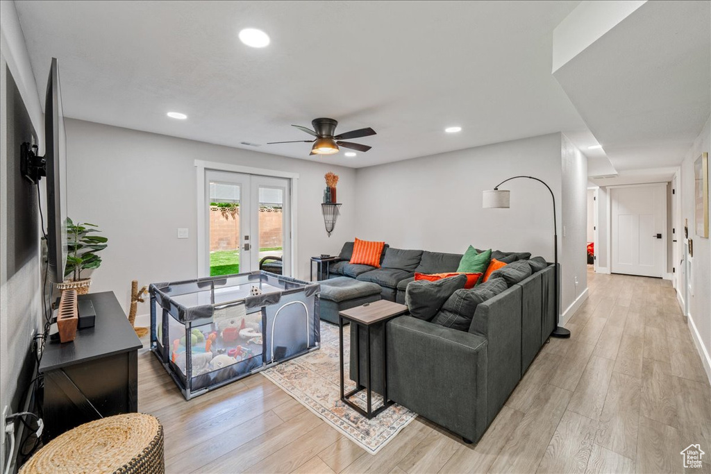 Living area with french doors, light wood finished floors, ceiling fan, and recessed lighting