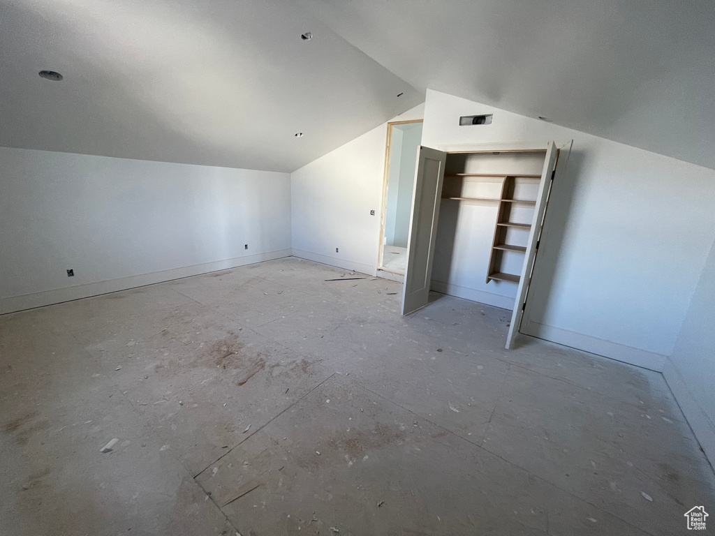Additional living space featuring lofted ceiling and baseboards