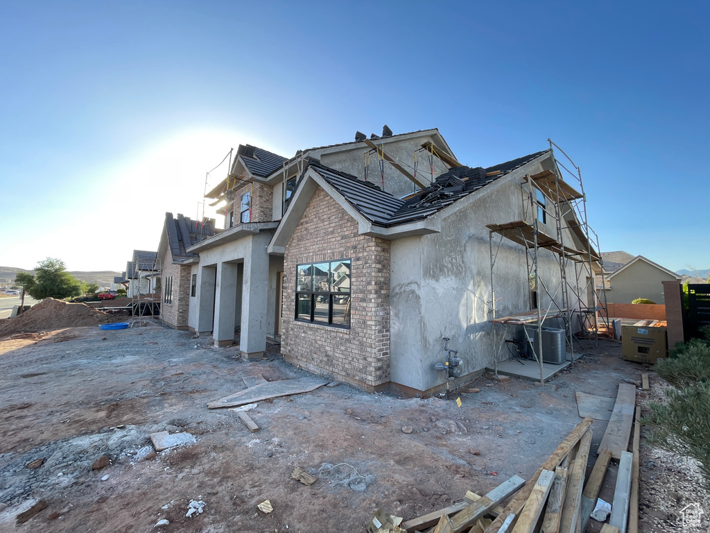 View of side of home with brick siding and stucco siding