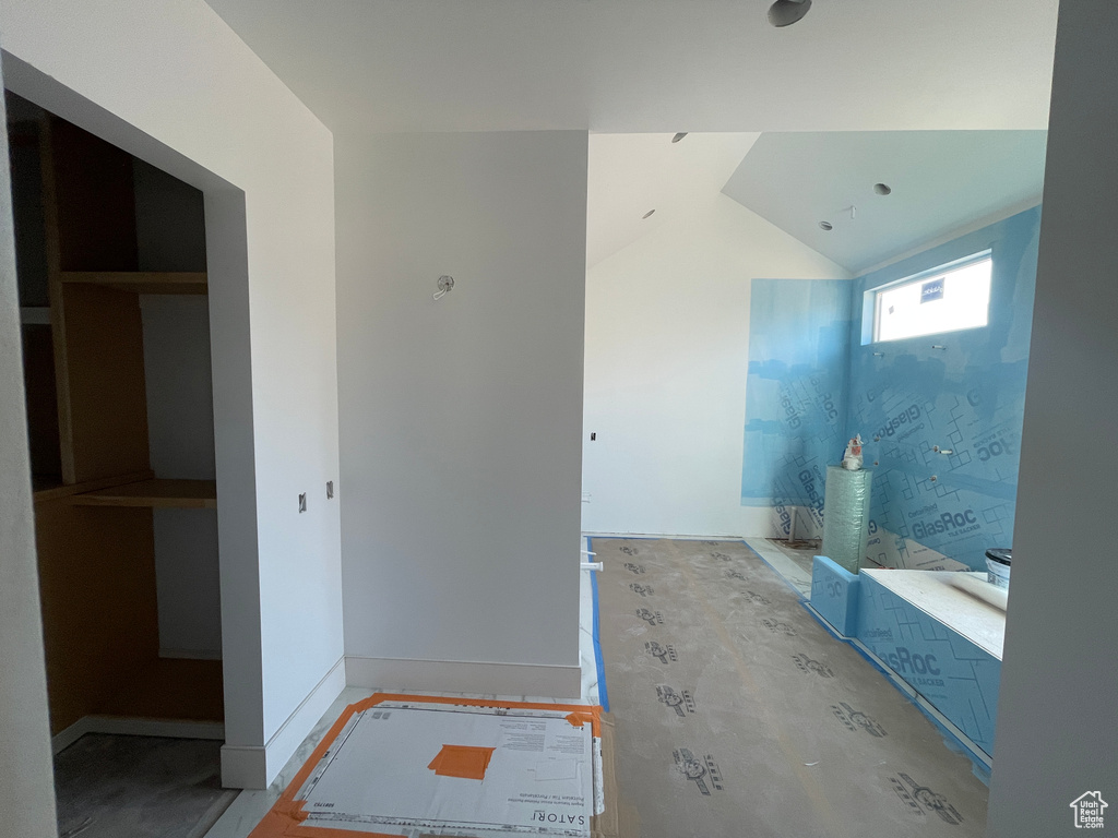 Bathroom featuring lofted ceiling and baseboards