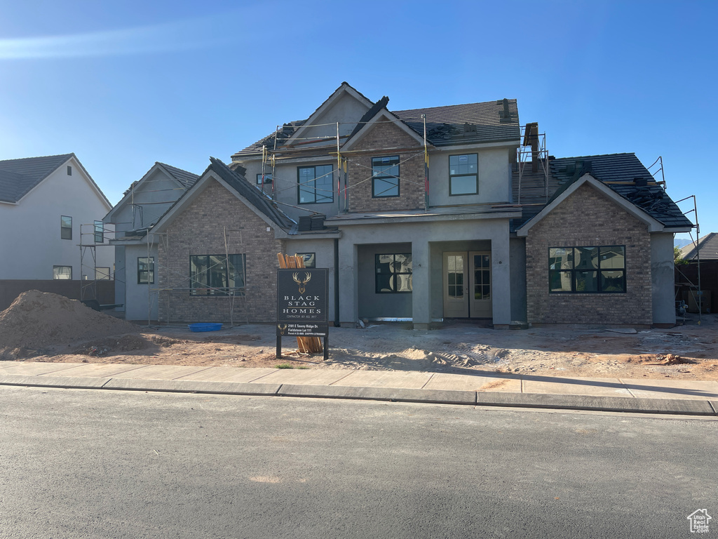 View of front of home with brick siding and stucco siding