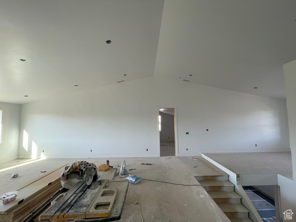 Unfurnished living room with vaulted ceiling