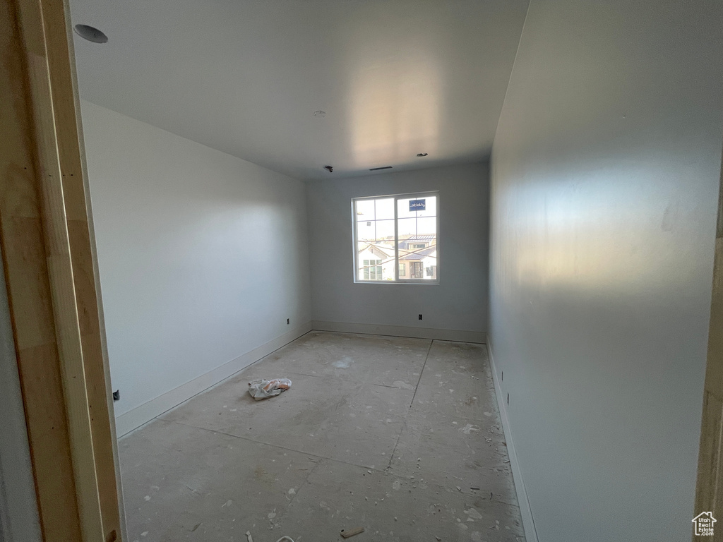Unfurnished room featuring baseboards