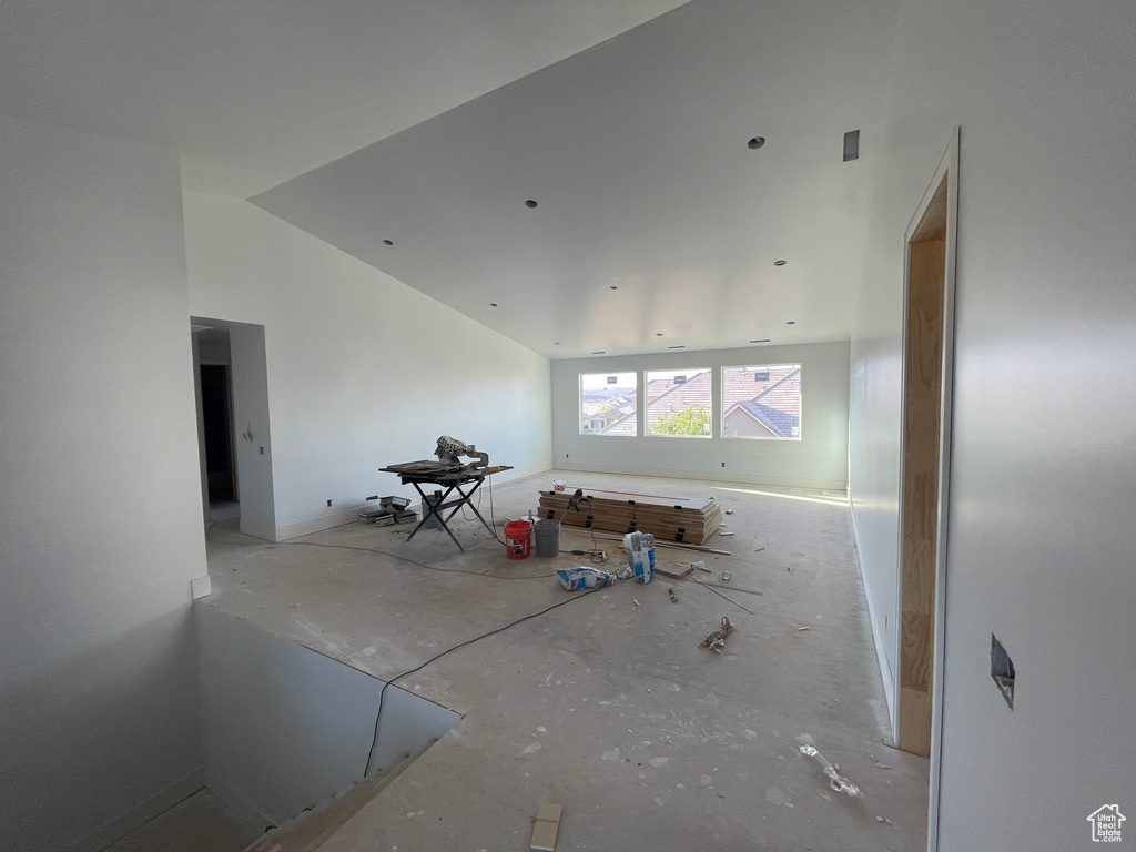 Empty room with lofted ceiling