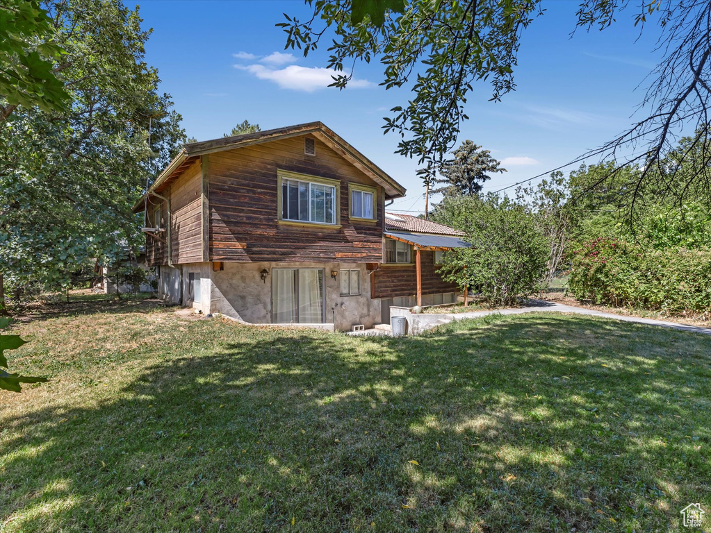 View of side of property with a yard