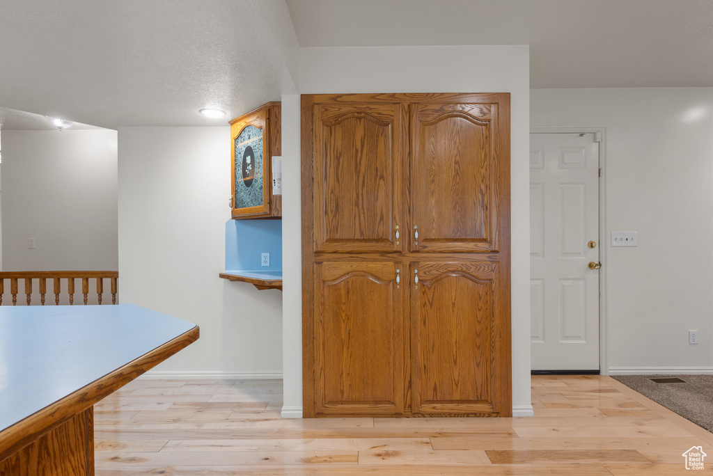 Hallway with light wood finished floors