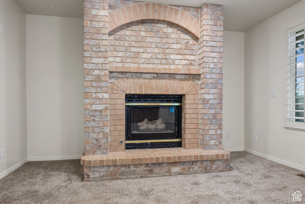 Detailed view of carpet and a fireplace