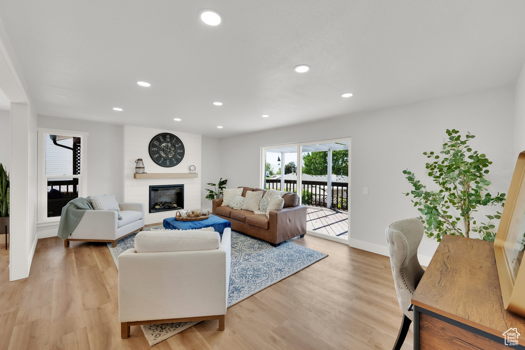 Living area featuring a fireplace, light wood-style floors, and recessed lighting