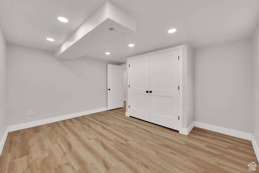 Finished basement with recessed lighting and light wood-type flooring