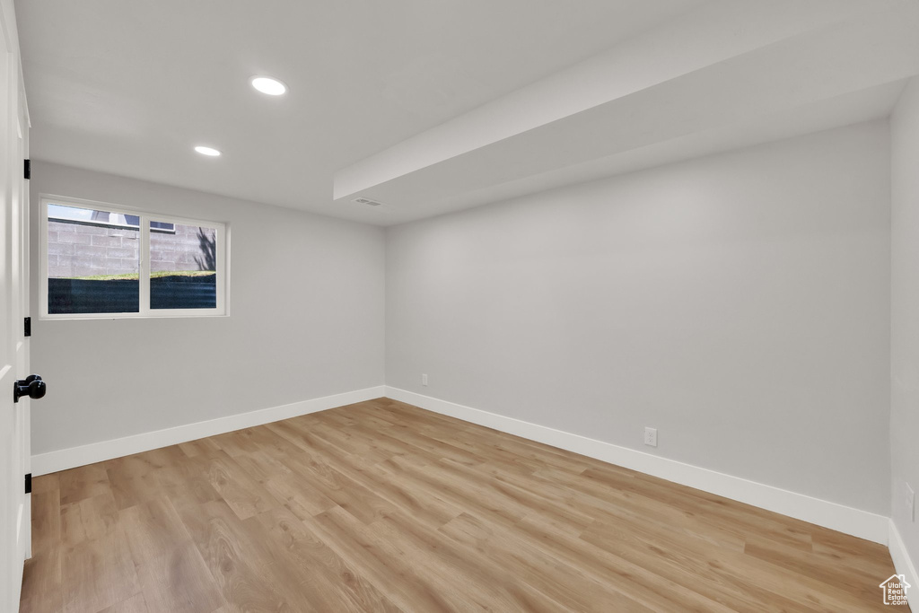 Empty room with recessed lighting and light wood-style flooring