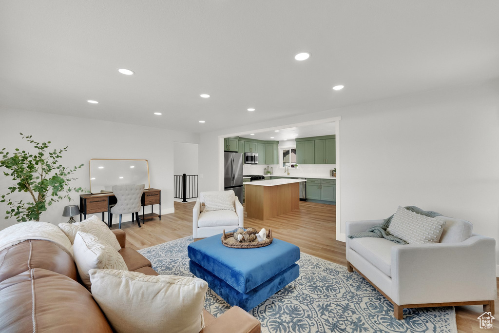 Living room featuring light wood finished floors and recessed lighting