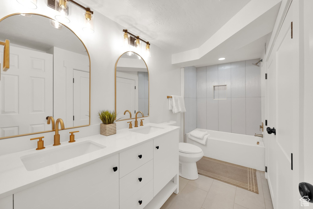 Bathroom with double vanity, tile patterned floors, shower / tub combination, and recessed lighting