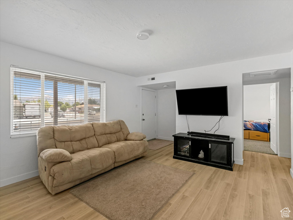 Living area featuring baseboards and light wood finished floors
