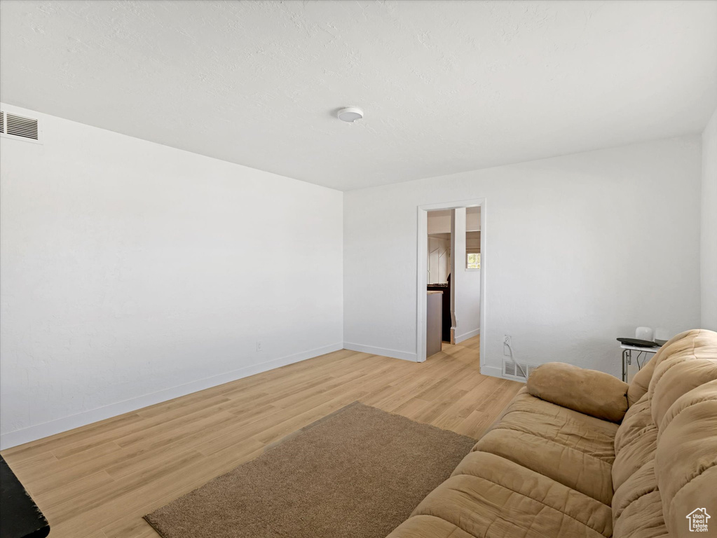Living area with light wood-style flooring and baseboards