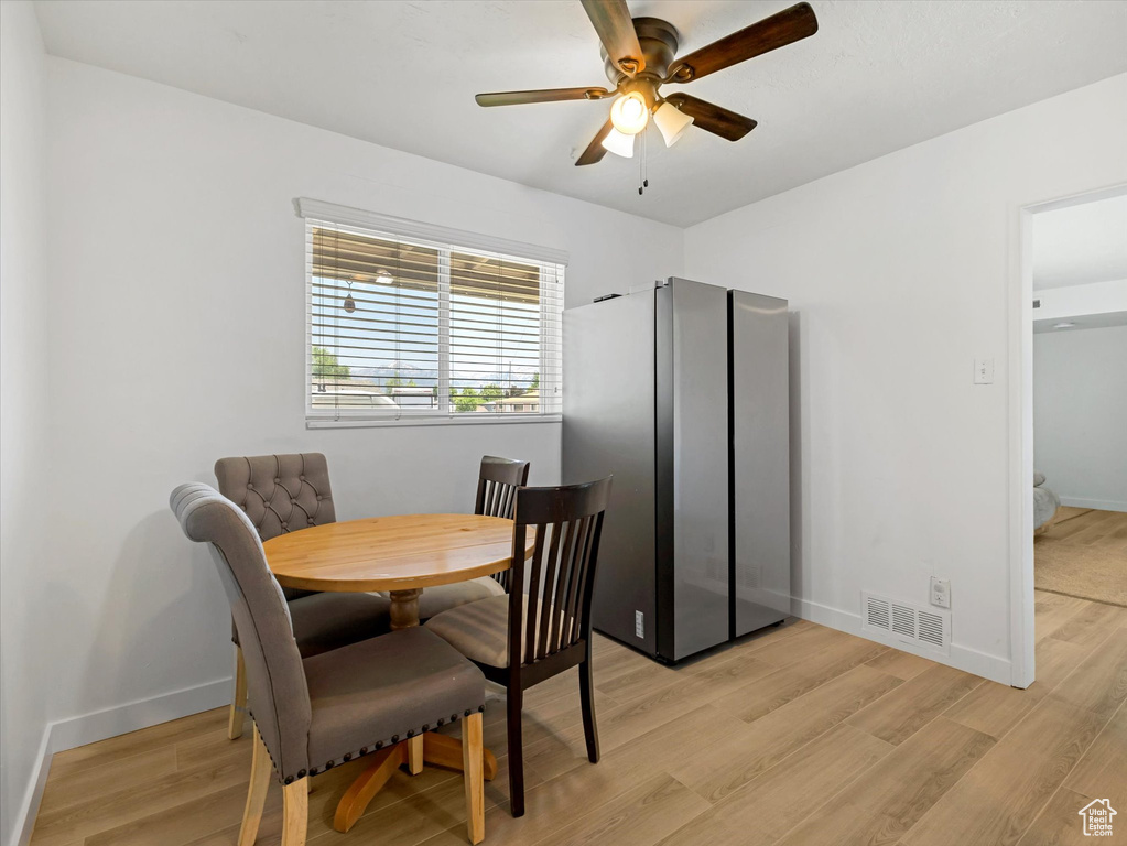 Dining area featuring ceiling fan and light wood-style flooring