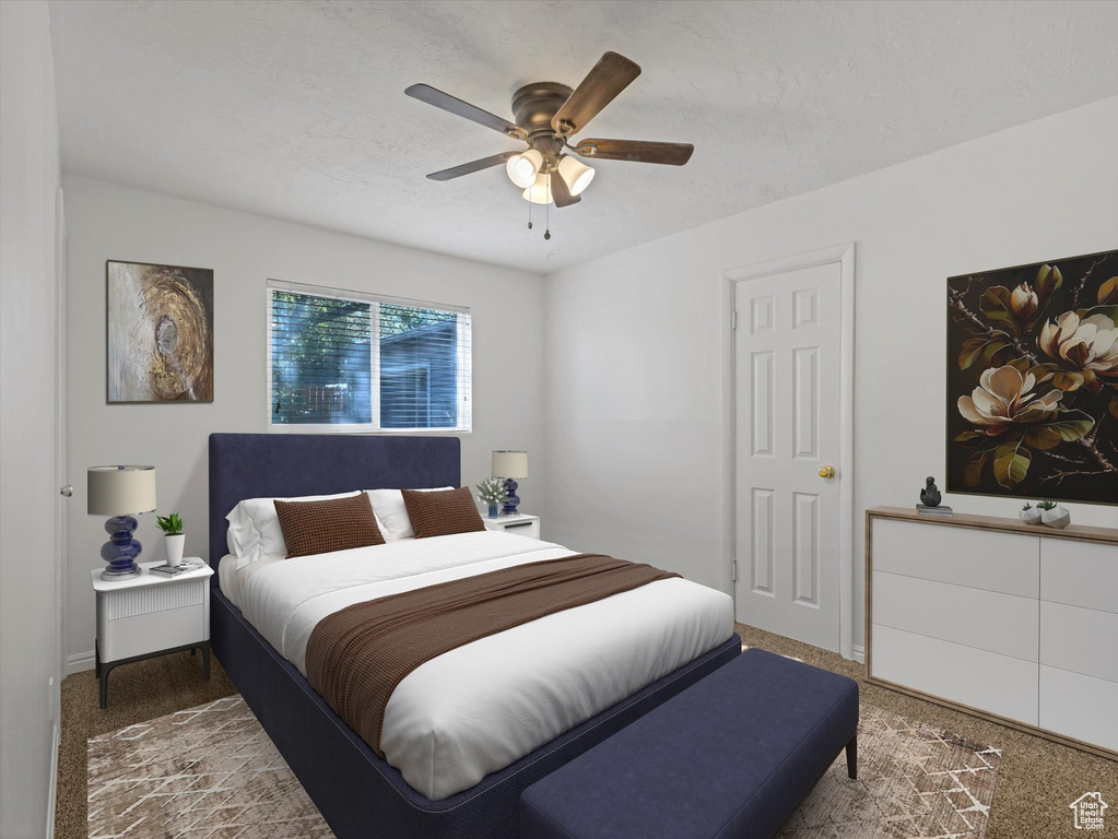 Bedroom with carpet floors, a ceiling fan, and a textured ceiling