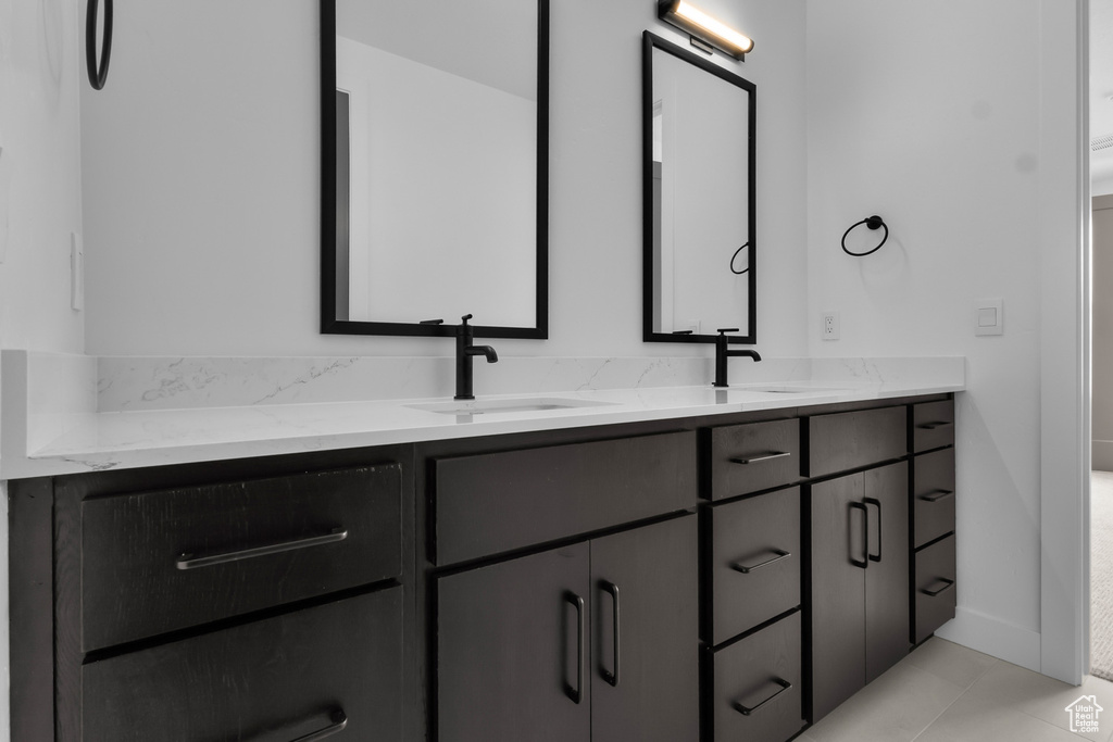 Full bath with double vanity and tile patterned floors