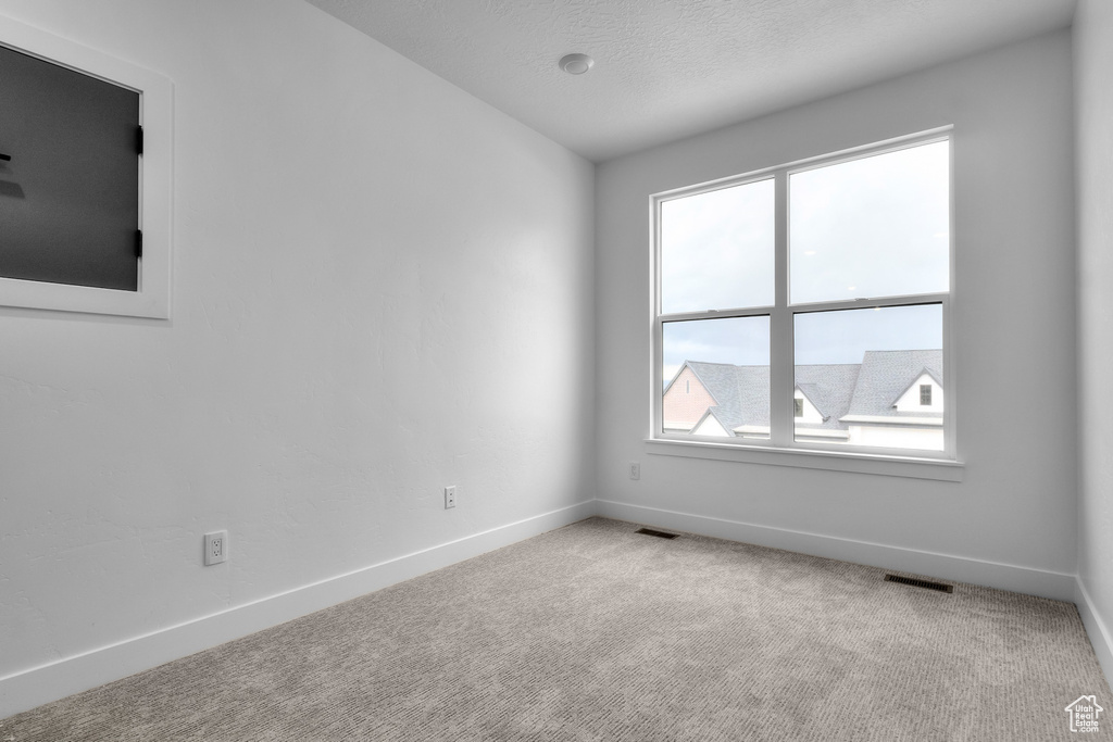 Carpeted spare room with baseboards