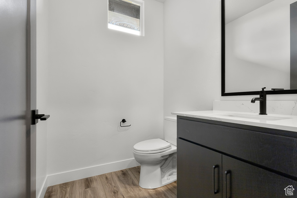 Bathroom featuring vanity and wood finished floors