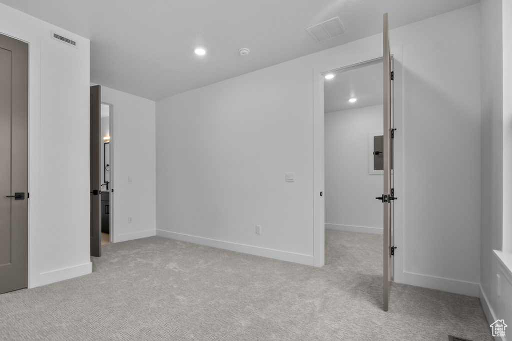 Unfurnished bedroom with carpet floors and recessed lighting