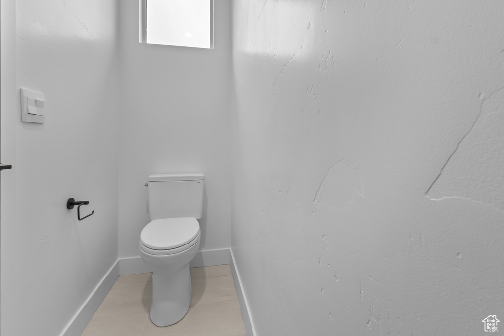 Bathroom with toilet and baseboards