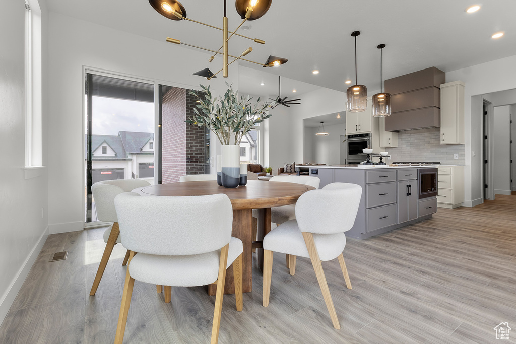 Dining room featuring a chandelier, light wood finished floors, and recessed lighting