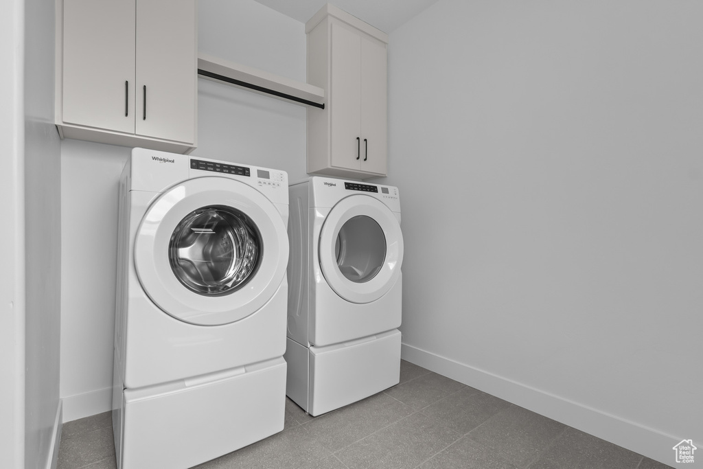 Washroom with washing machine and dryer and cabinet space