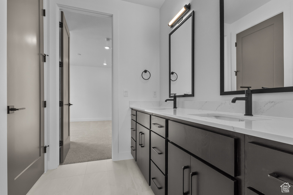 Bathroom featuring double vanity and baseboards