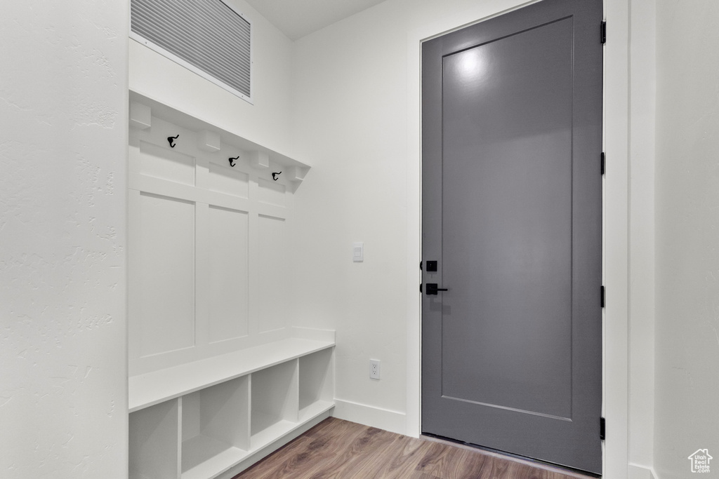 Mudroom featuring wood finished floors and baseboards