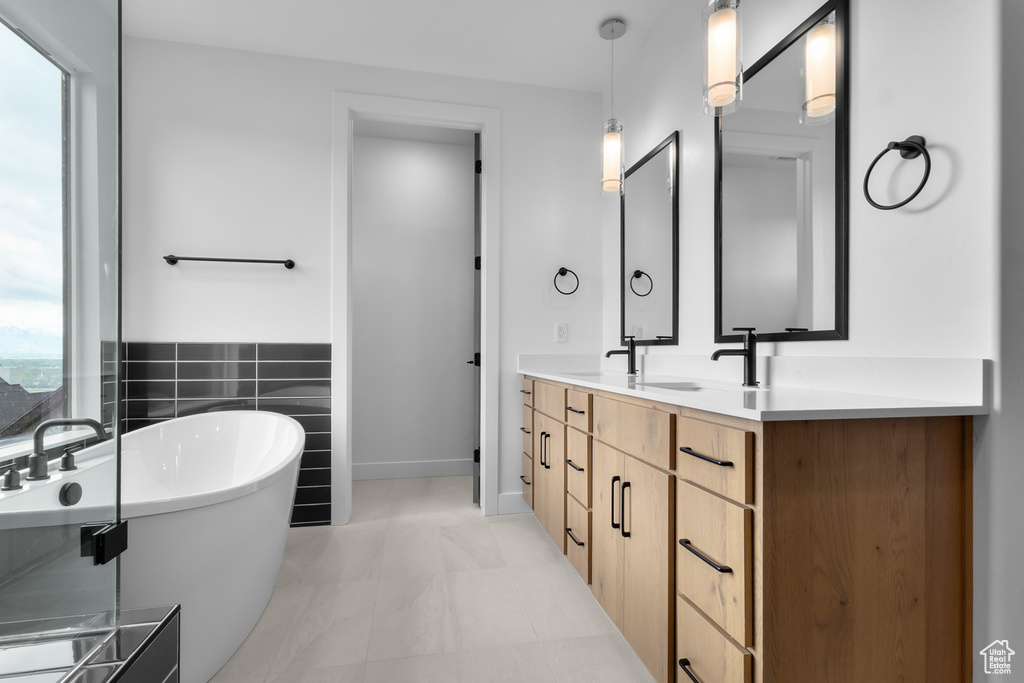 Full bath with double vanity and a freestanding bath